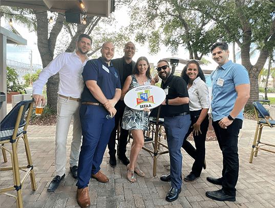 Association members networking at an outdoor event